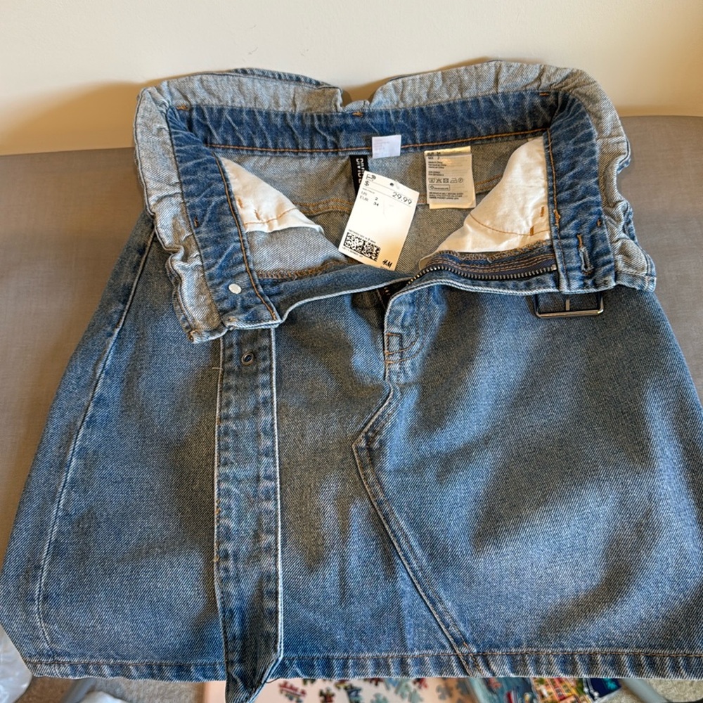 H&M Jean skirt with belt, worn once, still with tag. Flattering & comfortable!